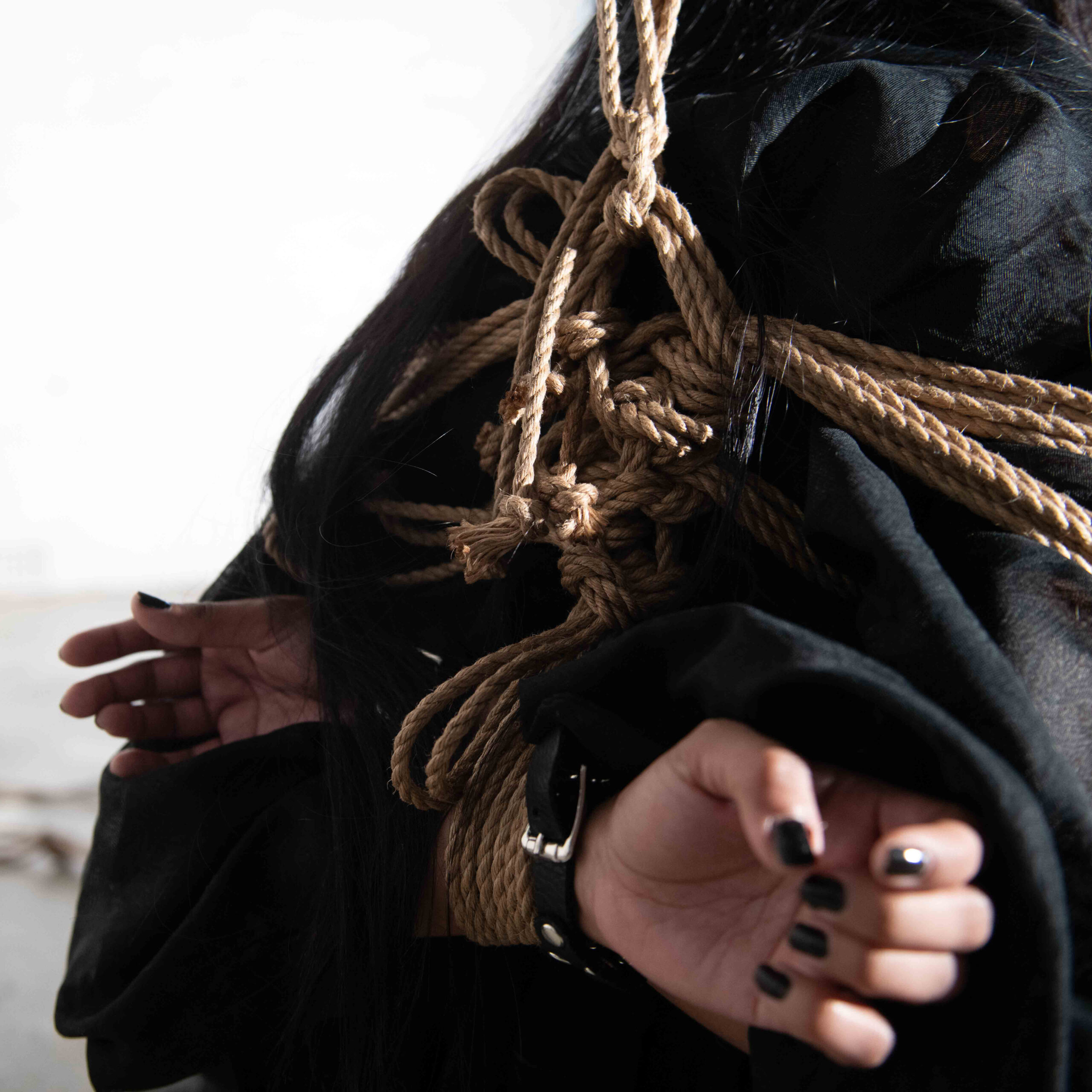 Shibari life drawing session at Vacant Assembly with a model in intricate rope poses and artists sketching.